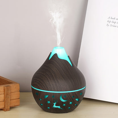 Aroma diffuser in donkere houtlook met turquoise licht